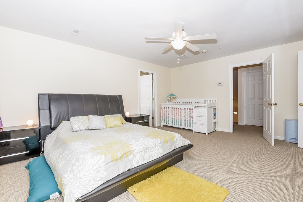 615 Nashua Road, Unit 9 Dracut, MA 01826 - Photo 22 of 30 a bedroom with a bed and cabinets