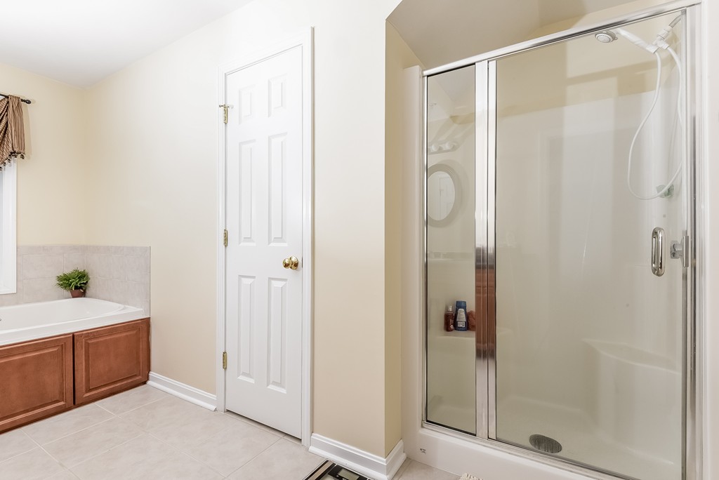 615 Nashua Road, Unit 9 Dracut, MA 01826 - Photo 24 of 30 a bathroom with a bathtub and a shower