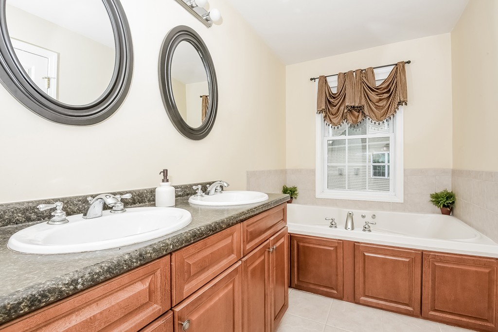 615 Nashua Road, Unit 9 Dracut, MA 01826 - Photo 25 of 30 a bathroom with a granite countertop double vanity sink and a mirror
