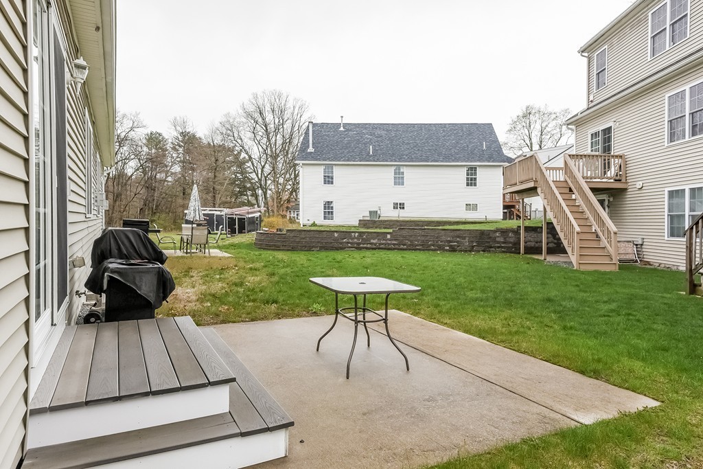 615 Nashua Road, Unit 9 Dracut, MA 01826 - Photo 28 of 30 a view of a house with backyard sitting area and garden