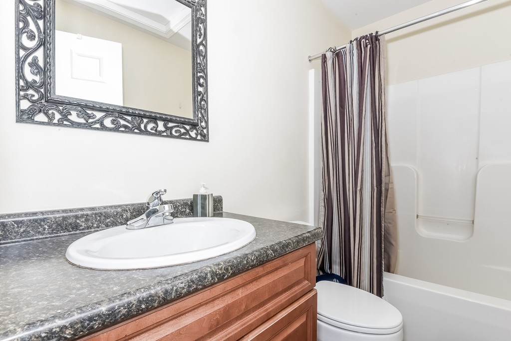 615 Nashua Road, Unit 9 Dracut, MA 01826 - Photo 29 of 30 a bathroom with a granite countertop sink toilet and shower