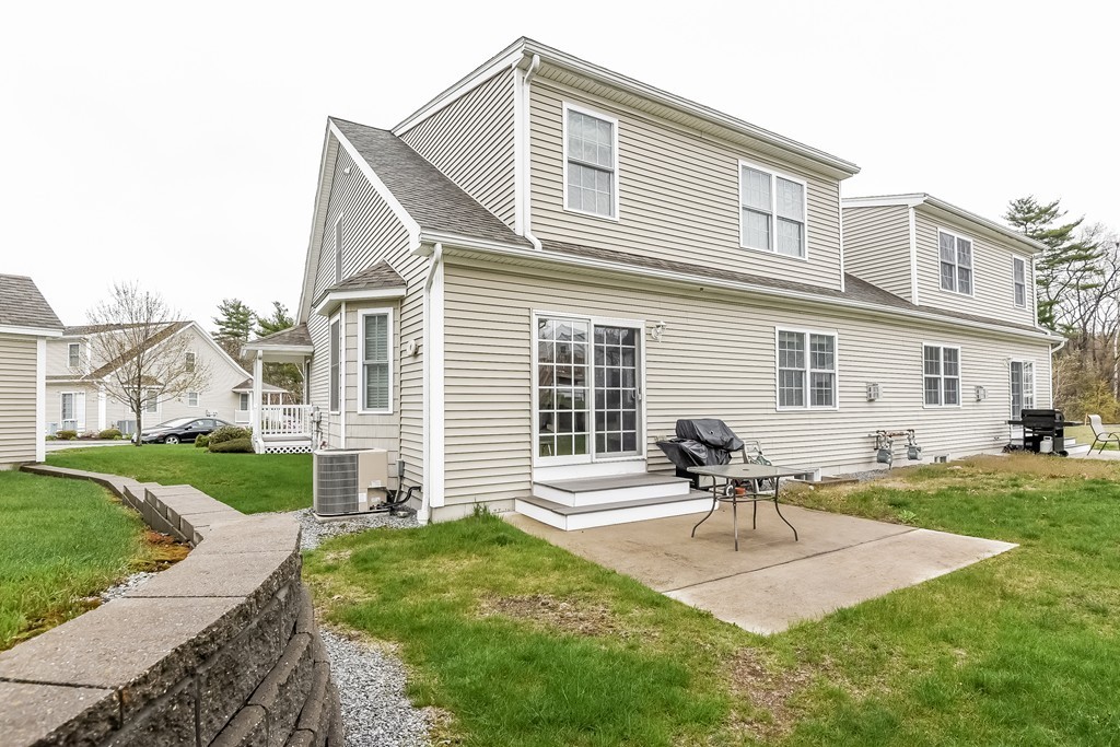 615 Nashua Road, Unit 9 Dracut, MA 01826 - Photo 30 of 30 a house view with a sitting space and garden