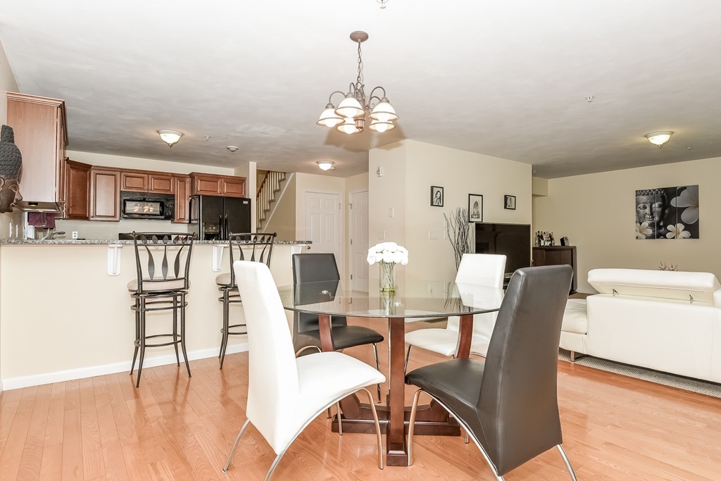 615 Nashua Road, Unit 9 Dracut, MA 01826 - Photo 8 of 30 a view of a dining room with furniture and wooden floor