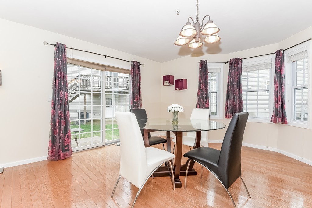 615 Nashua Road, Unit 9 Dracut, MA 01826 - Photo 9 of 30 a view of a dining room with furniture wooden floor and chandelier