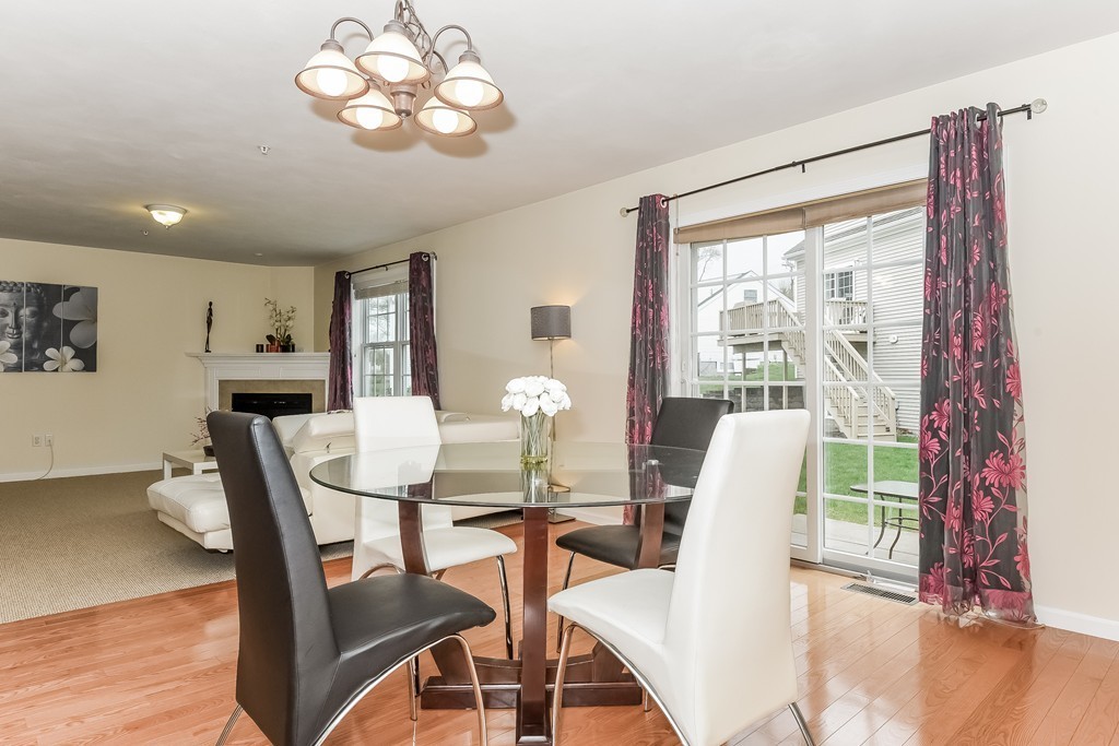 615 Nashua Road, Unit 9 Dracut, MA 01826 - Photo 10 of 30 a view of a dining room with furniture a chandelier and wooden floor