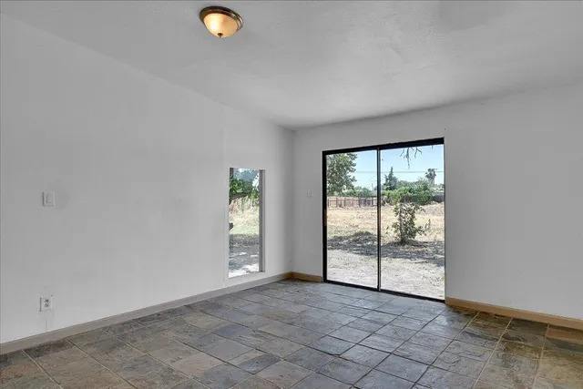 a kitchen with granite countertop a refrigerator and a stove top oven