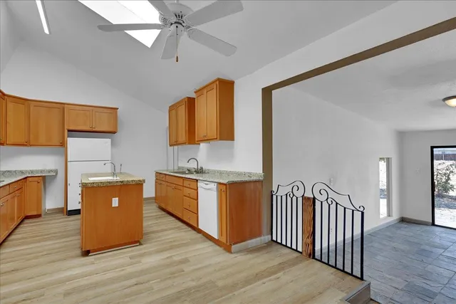a kitchen with granite countertop a stove microwave and sink