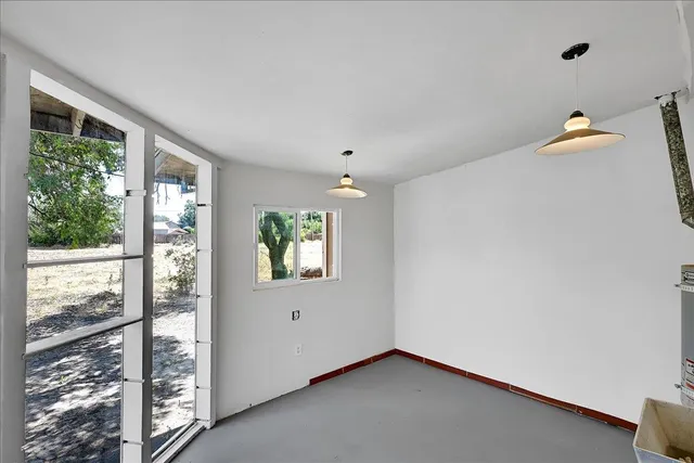 a view of an empty room with windows and closet