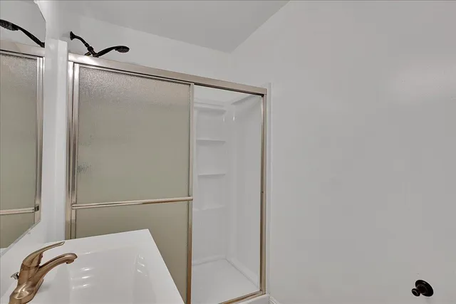 a backyard of a house with large trees and wooden fence