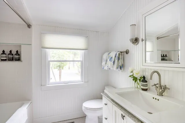 a bathroom with a sink toilet and a mirror