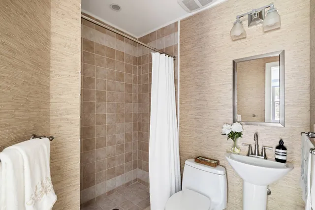 a bathroom with a sink toilet and shower