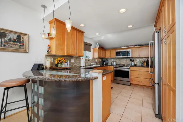 a kitchen with stainless steel appliances granite countertop a sink counter space cabinets and a stove