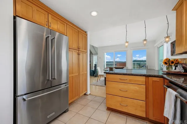 a kitchen with stainless steel appliances granite countertop a refrigerator and a sink