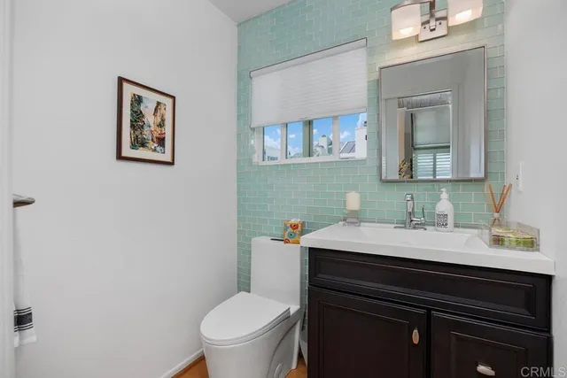 a bathroom with a sink vanity and a toilet