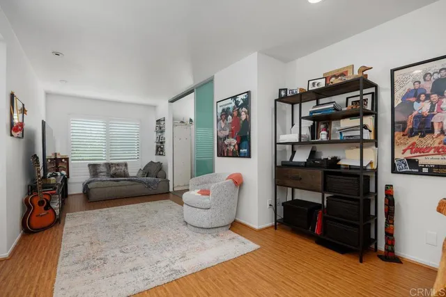 a living room with furniture cabinets and window