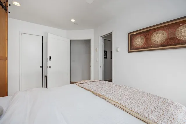 a bedroom with bed and wall painting