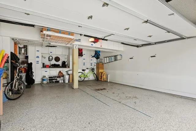 a view of a garage with rack and bicycle