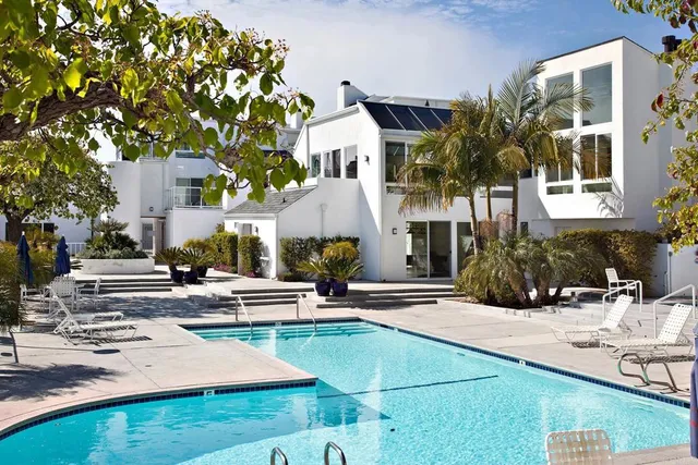 a view of a building with yard and sitting area