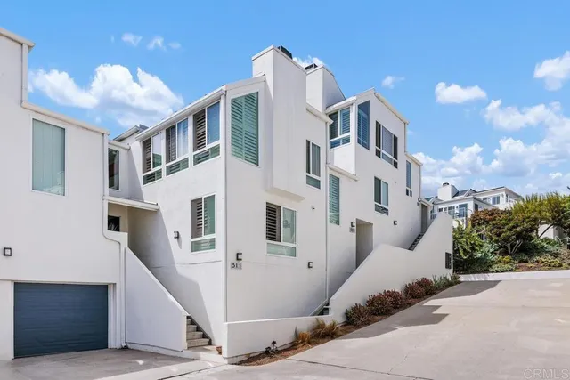 a view of a white apartments with large windows