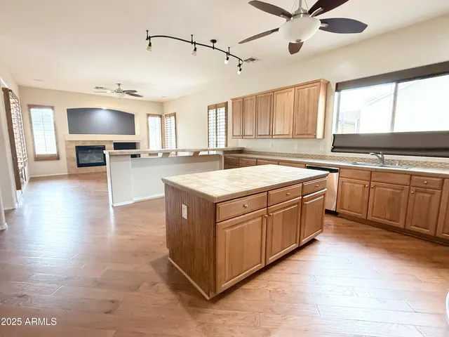 a kitchen with a stove sink and cabinets