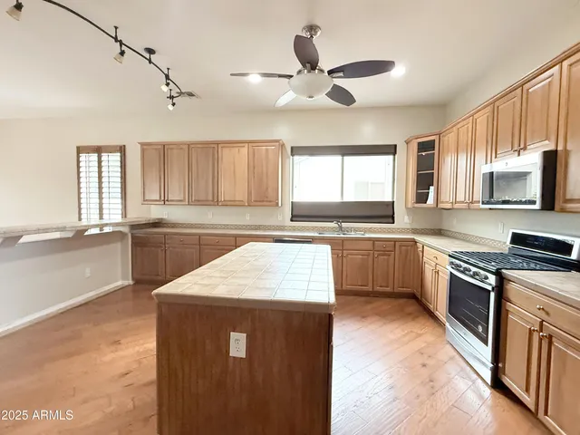 a kitchen with a stove a sink and a microwave