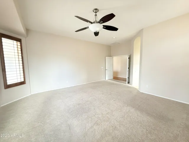 an empty room with closet and windows