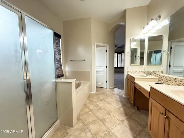 a large bathroom with a granite countertop sink mirror and shower