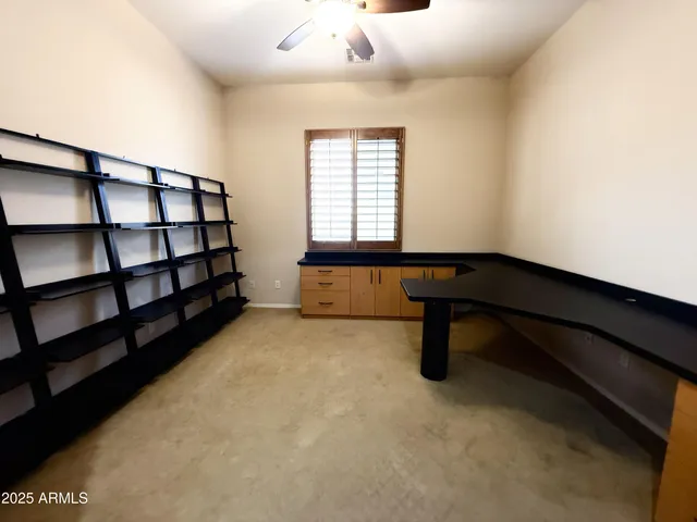 a room with pool table and window