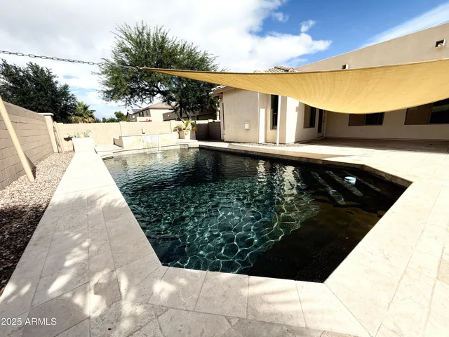 a view of a swimming pool with a patio