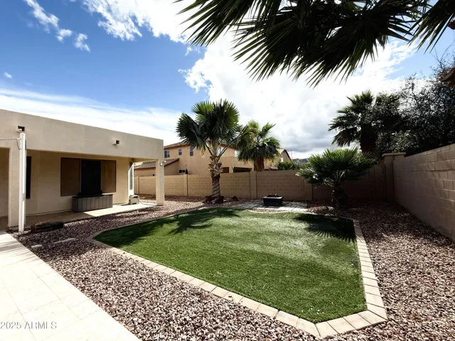 a front view of a house with a garden and yard