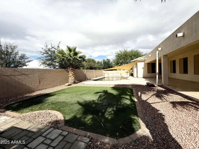 a view of a backyard with sitting area