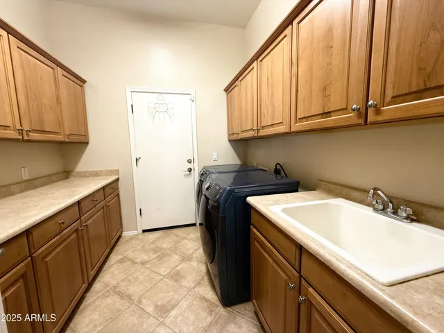 a utility room with a sink a washer and dryer