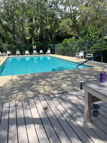 a view of a swimming pool with a yard