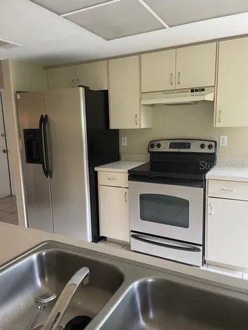 a kitchen with a sink and a refrigerator