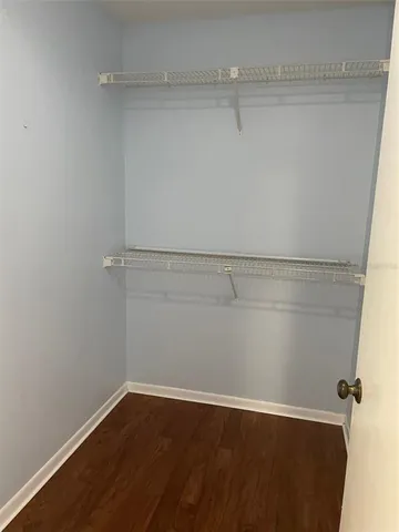 a view of a room with wooden floor