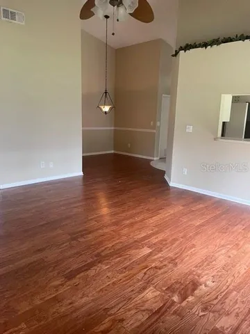 an empty room with wooden floor