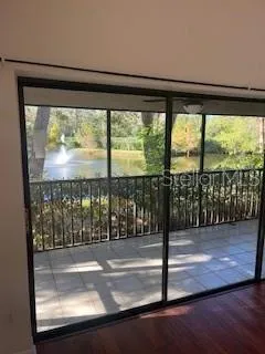 a view of a floor to ceiling window and wooden floor