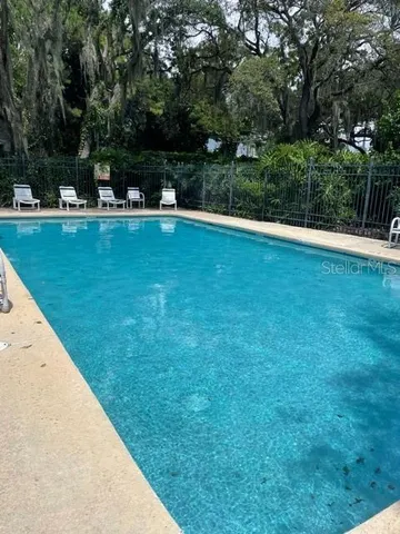 a view of a swimming pool with a yard