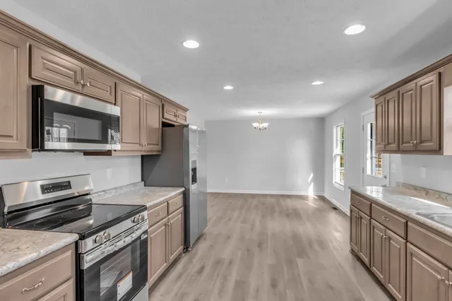 a kitchen with a sink stove and microwave