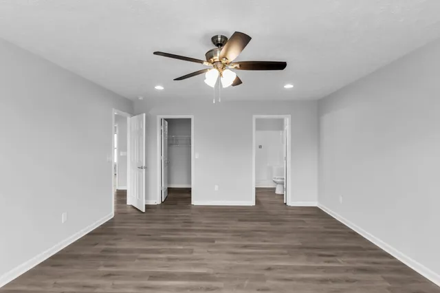 a view of empty room with wooden floor