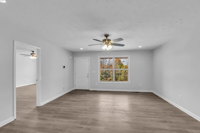 wooden floor in an empty room with a window