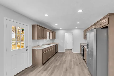 a view of a kitchen with a sink and a refrigerator