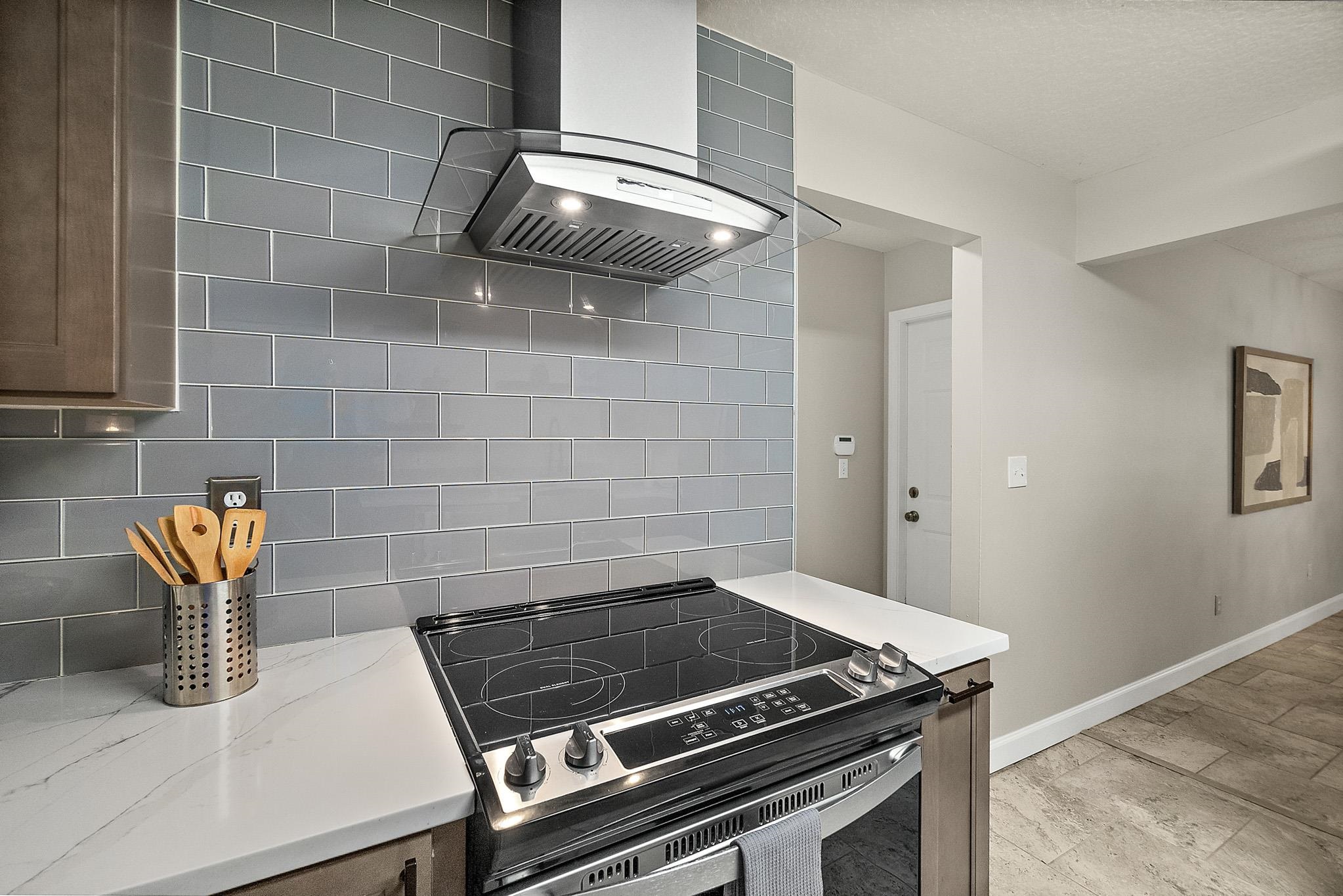 3253 Turtle Creek Road St. Augustine, FL 32086 - Photo 10 of 40 Kitchen featuring electric range oven, light stone countertops, and decorative backsplash