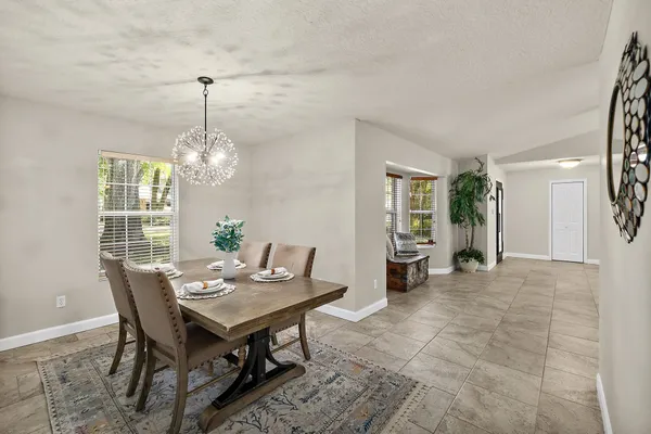 a view of a dining room with furniture and chandelier