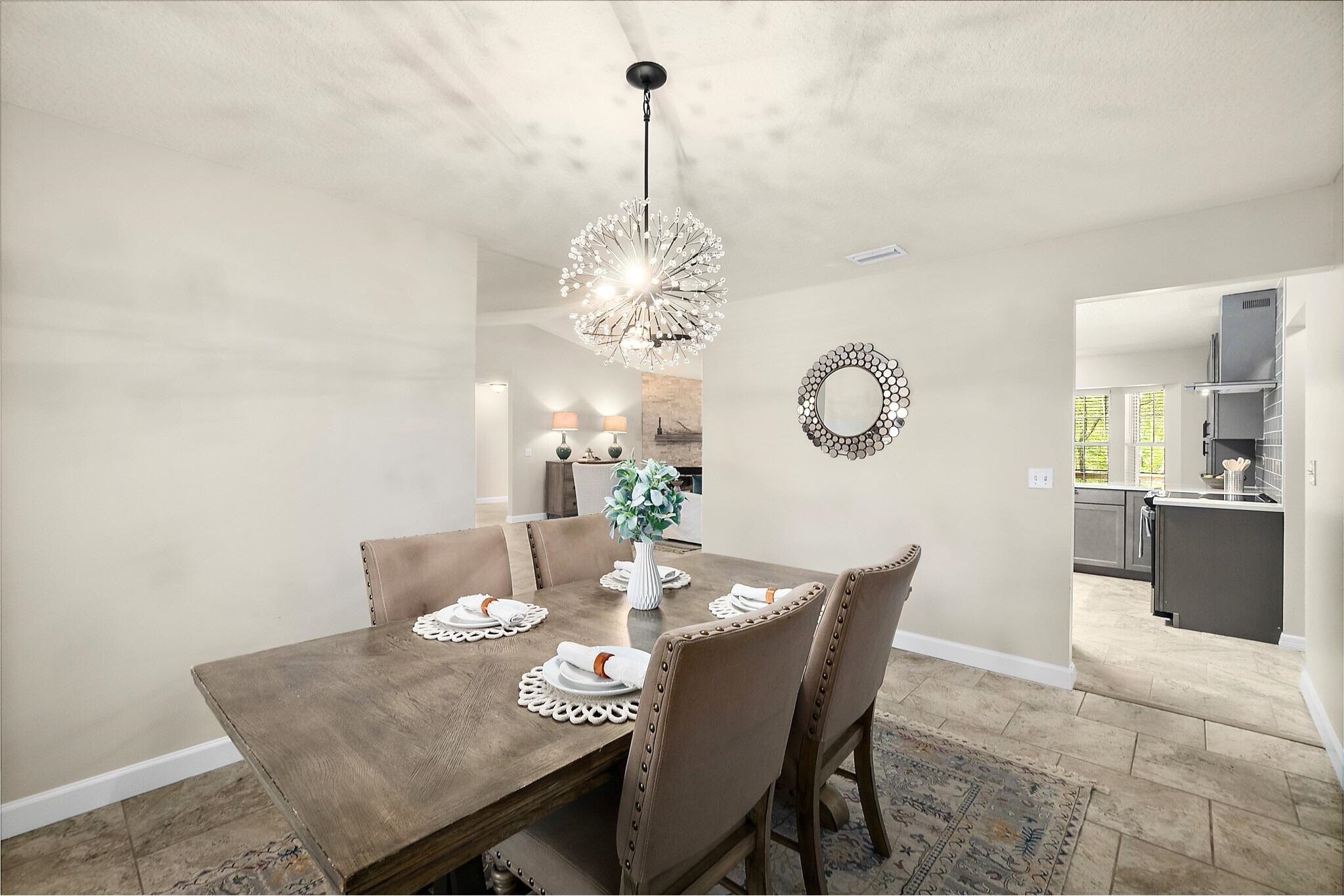 3253 Turtle Creek Road St. Augustine, FL 32086 - Photo 14 of 40 Dining room with stone tile floors, hanging lights, and a textured ceiling
