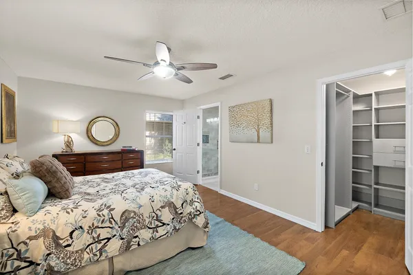 a bedroom with a bed dresser and a window