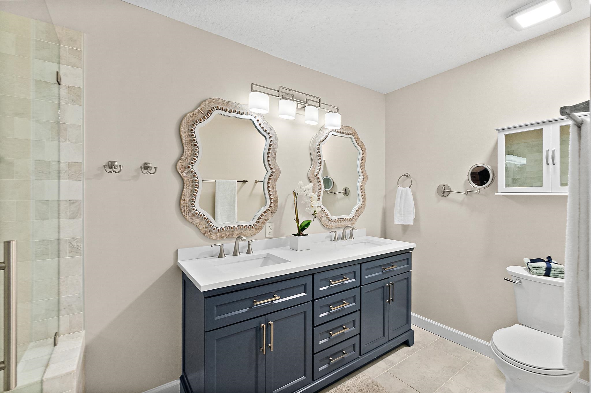 3253 Turtle Creek Road St. Augustine, FL 32086 - Photo 18 of 40 Bathroom with double vanity, a stall shower, and light tile patterned flooring