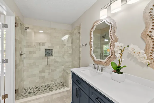 a bathroom with a double vanity sink and a mirror