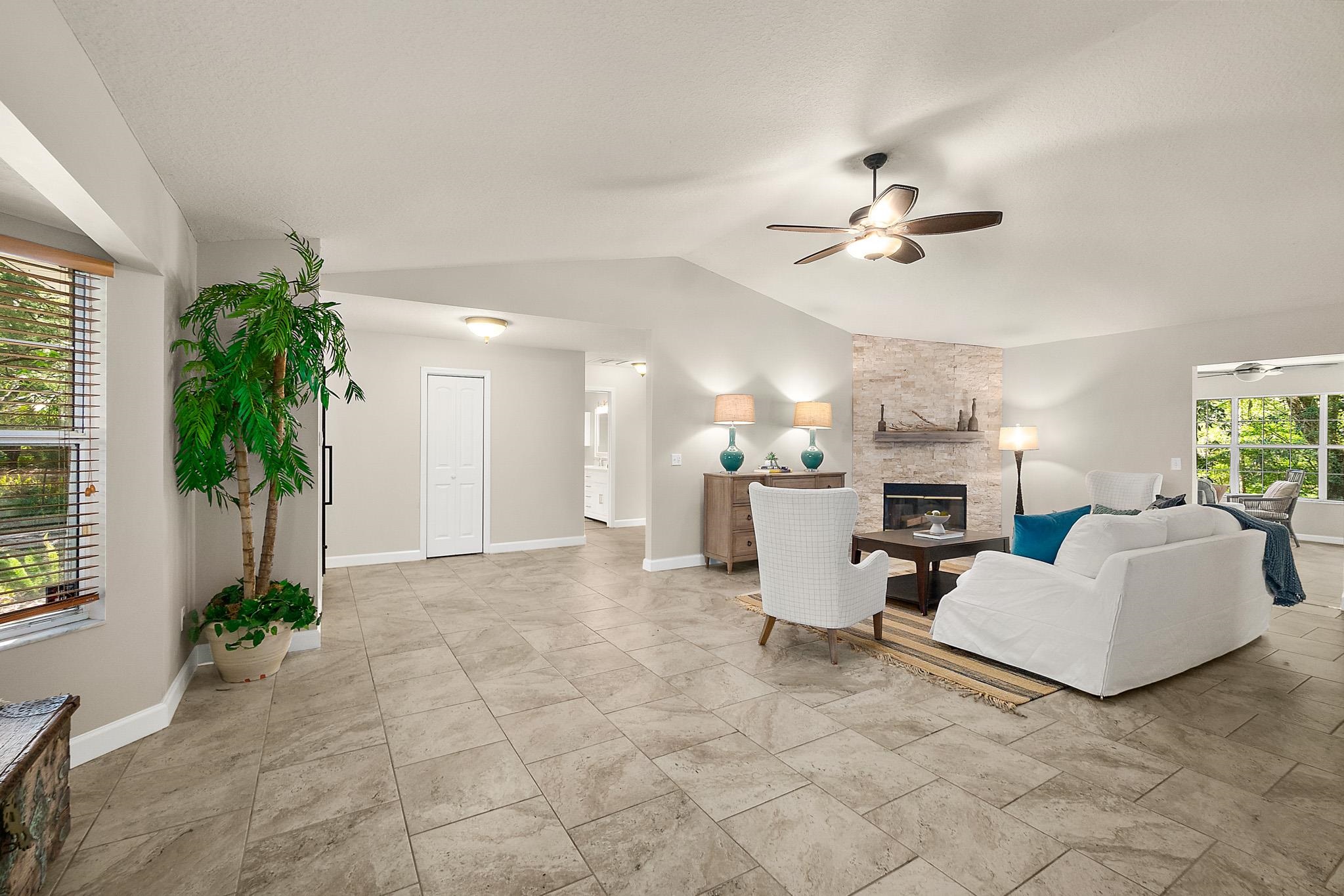 3253 Turtle Creek Road St. Augustine, FL 32086 - Photo 20 of 40 Living room featuring ceiling fan and a stone fireplace