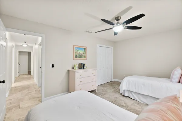 a bedroom with two beds and a chandelier